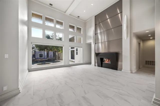 a view of an empty room with a fireplace and a window