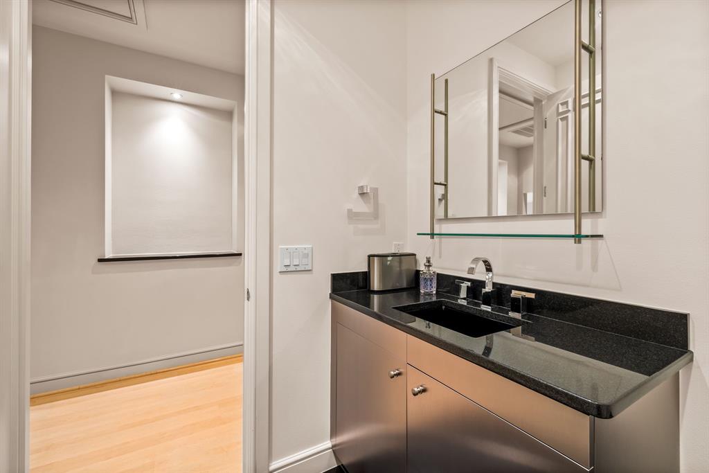 5608 Stone Cliff Court Dallas, TX 75287 - Photo 31 of 35 a bathroom with a sink and a mirror