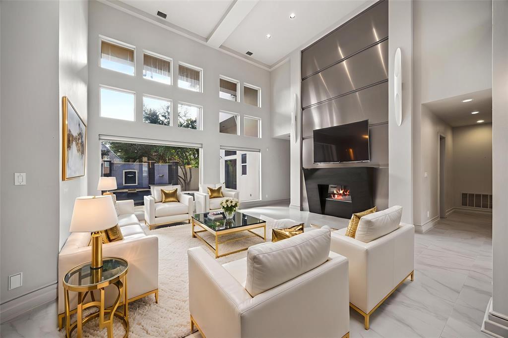 5608 Stone Cliff Court Dallas, TX 75287 - Photo 4 of 35 a living room with fireplace furniture and a flat screen tv