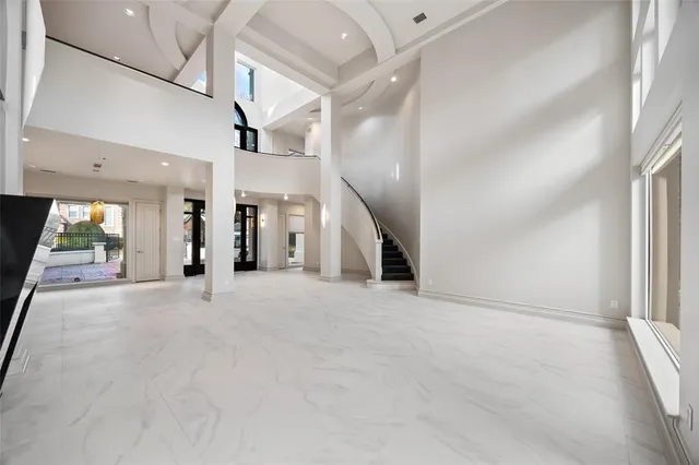 an empty room with fireplace and windows