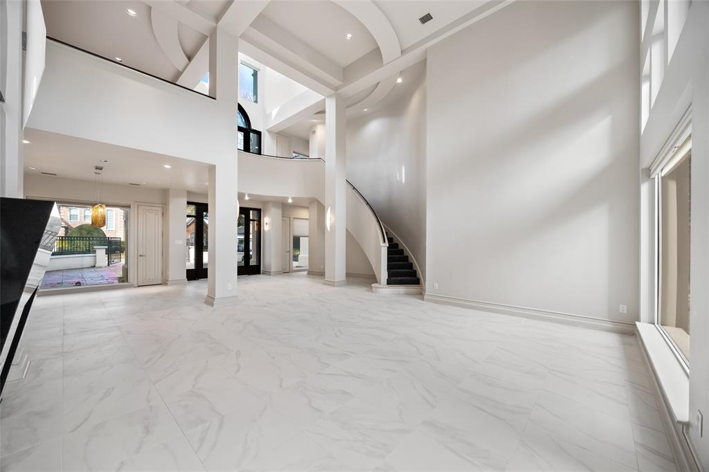 5608 Stone Cliff Court Dallas, TX 75287 - Photo 6 of 35 an empty room with fireplace and windows