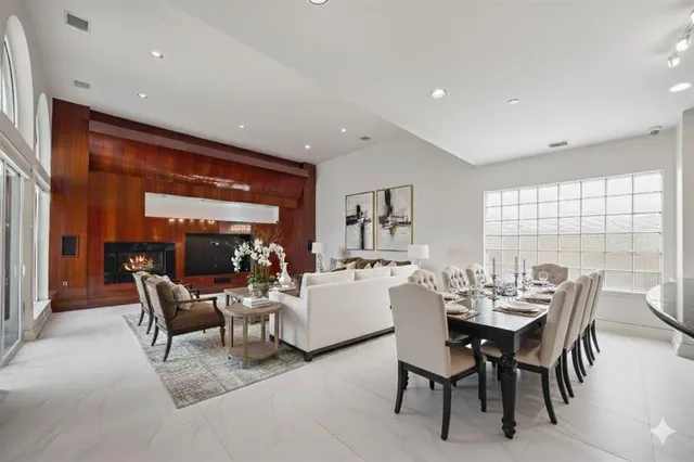 a dining room with furniture and a large window
