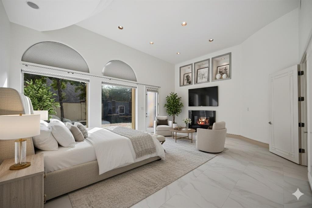 5608 Stone Cliff Court Dallas, TX 75287 - Photo 9 of 35 a bed room with furniture and a fireplace