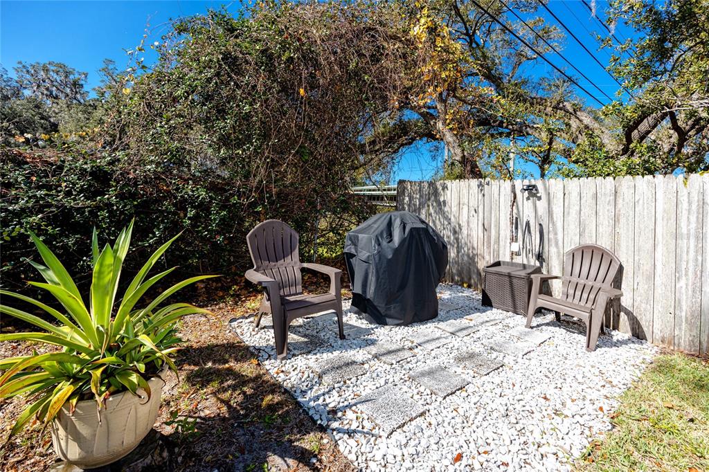 5596 100th Way North St. Petersburg, FL 33708 - Photo 58 of 67 a view of a chairs and table in backyard