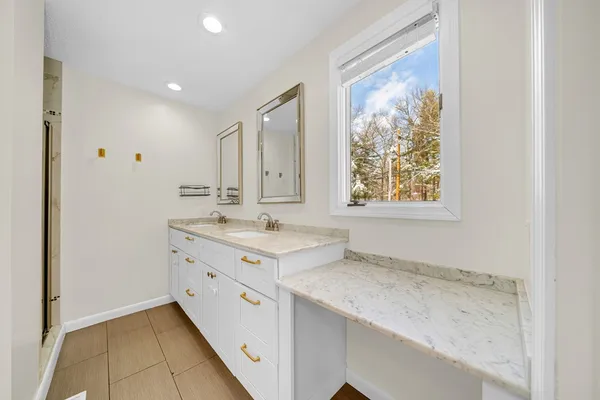 a bathroom with a sink a vanity and a mirror