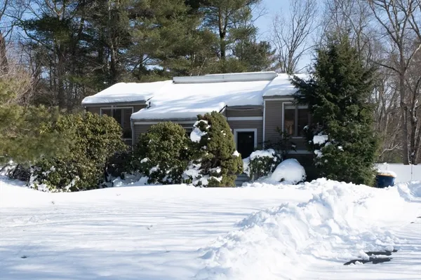 a view of a house with snow in the yard
