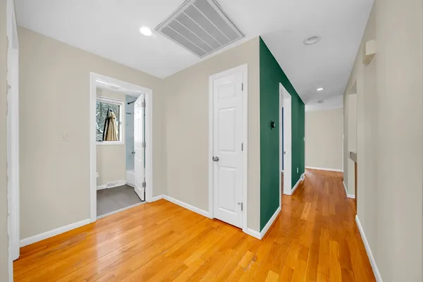 a view of hallway with wooden floor