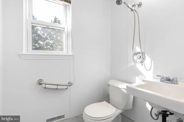 a white toilet sitting next to a bathroom sink
