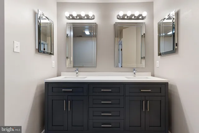 a bathroom with a double vanity sink and a mirror