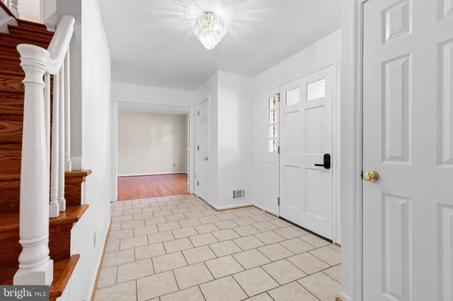 a view of a bathroom with mirror and shower