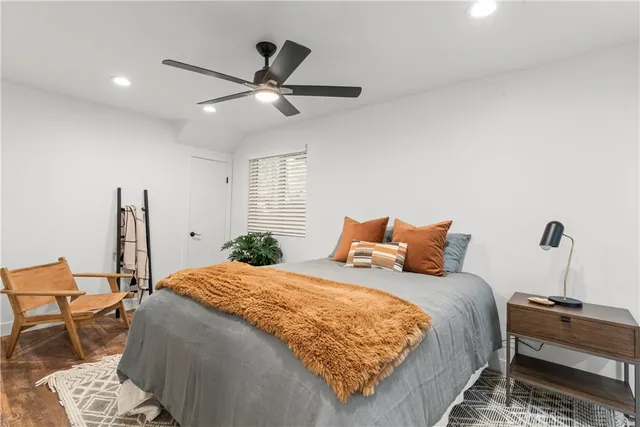 a bedroom with a large bed and a chandelier