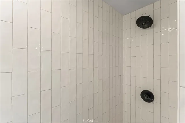 a bathroom with a sink a toilet a mirror and shower