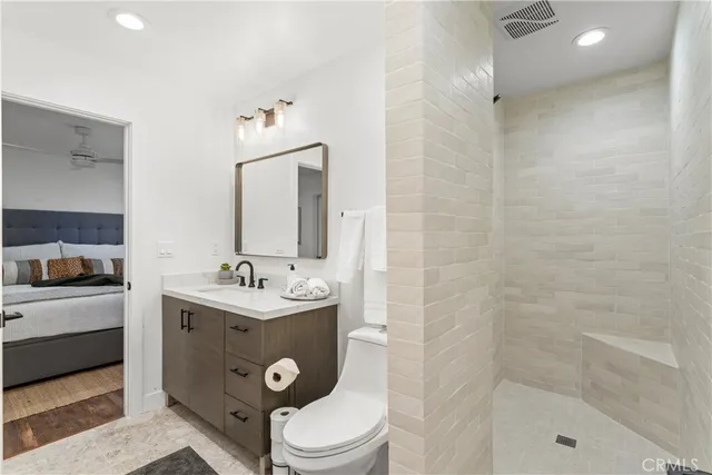 a bedroom with a bed and a potted plant