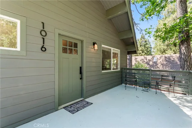 a living room with furniture fireplace and a large window