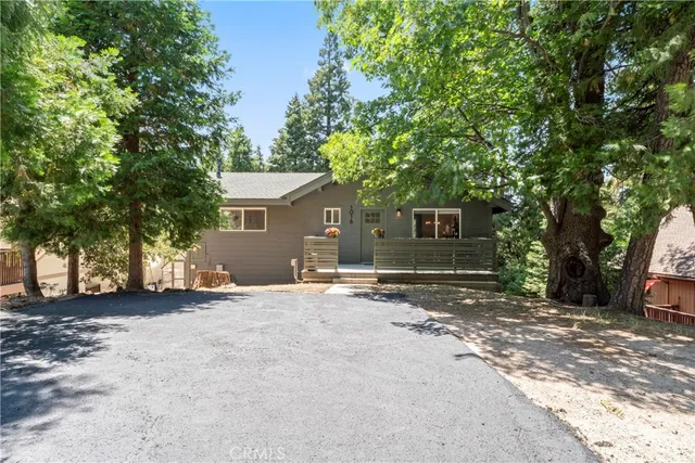 an aerial view of houses with a lush green hillside