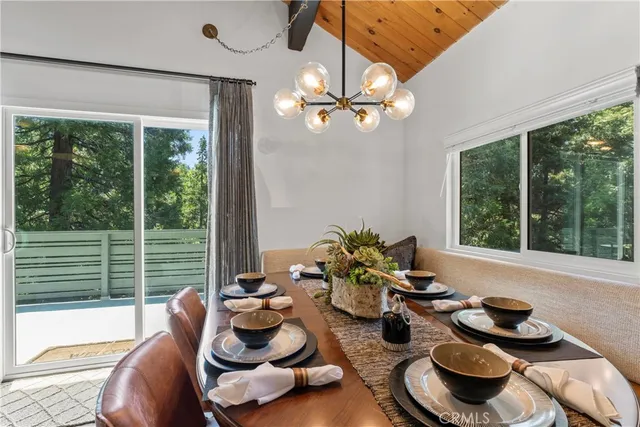a view of kitchen with stainless steel appliances granite countertop a stove and a wooden floors