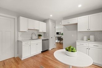 2 Barracks Road, Unit 2 Hudson, MA 01749 - Photo 3 of 12 a kitchen with granite countertop white cabinets white appliances a sink and a stove