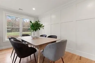 a view of a dining room with furniture and a window