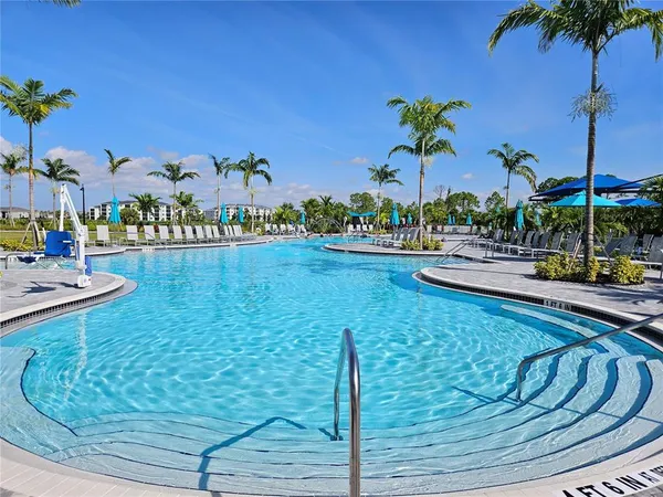 a view of a swimming pool with a table and chairs