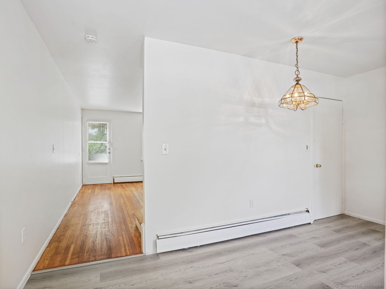 85 Abner Court, Unit 85 Bridgeport, CT 06606 - Photo 13 of 31 an empty room with wooden floor and windows