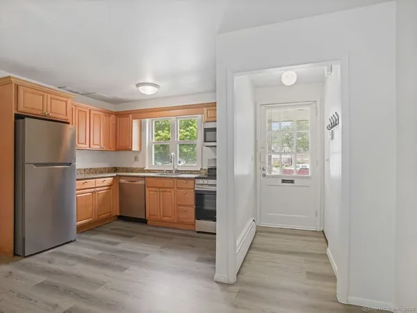 a kitchen with a refrigerator and a stove top oven