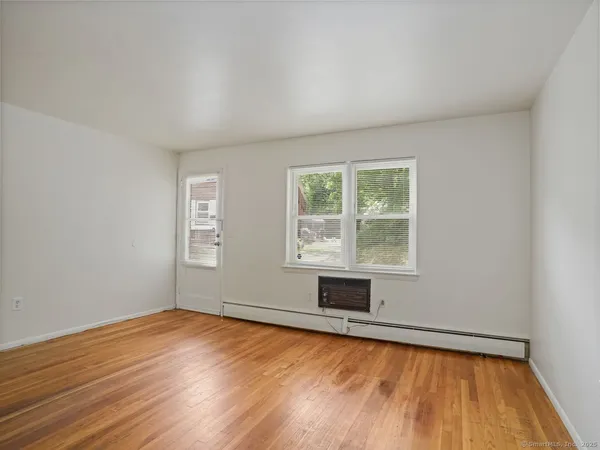 wooden floor in an empty room with a window