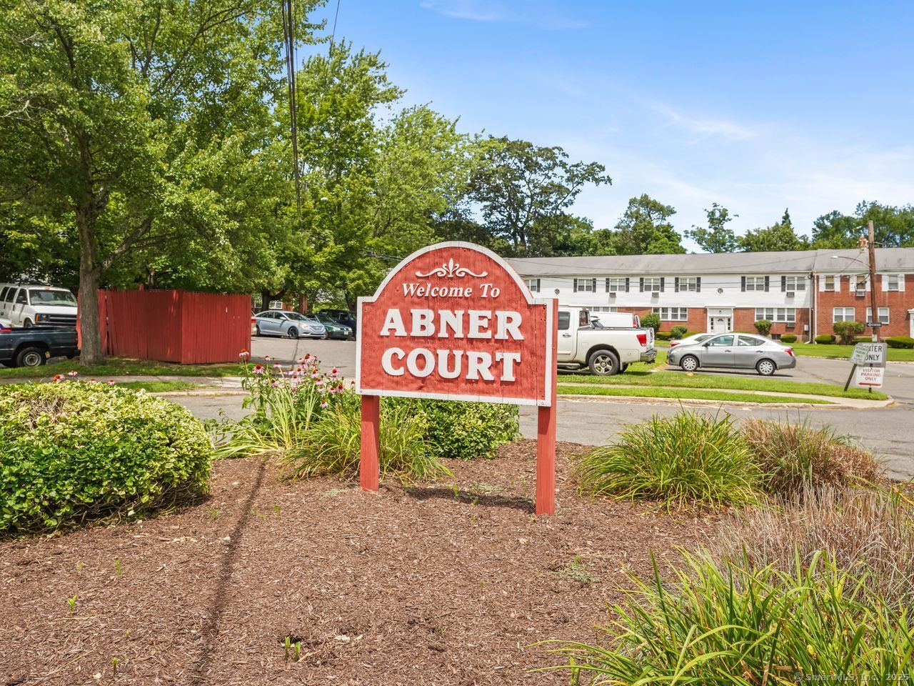 85 Abner Court, Unit 85 Bridgeport, CT 06606 - Photo 2 of 31 a sign board with a play ground in the back