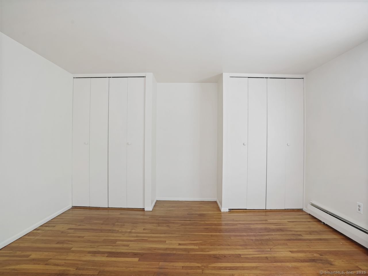 85 Abner Court, Unit 85 Bridgeport, CT 06606 - Photo 23 of 31 a view of an empty room with wooden floor