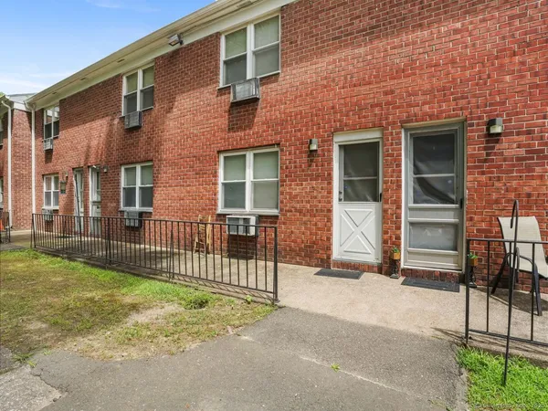 a view of a brick house with many windows