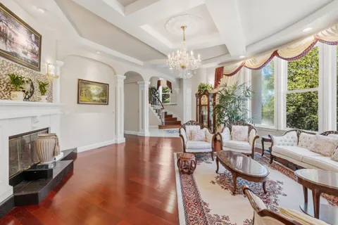 a living room with furniture fireplace and a large window