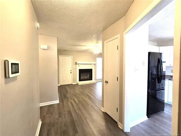 a view of hallway with wooden floor