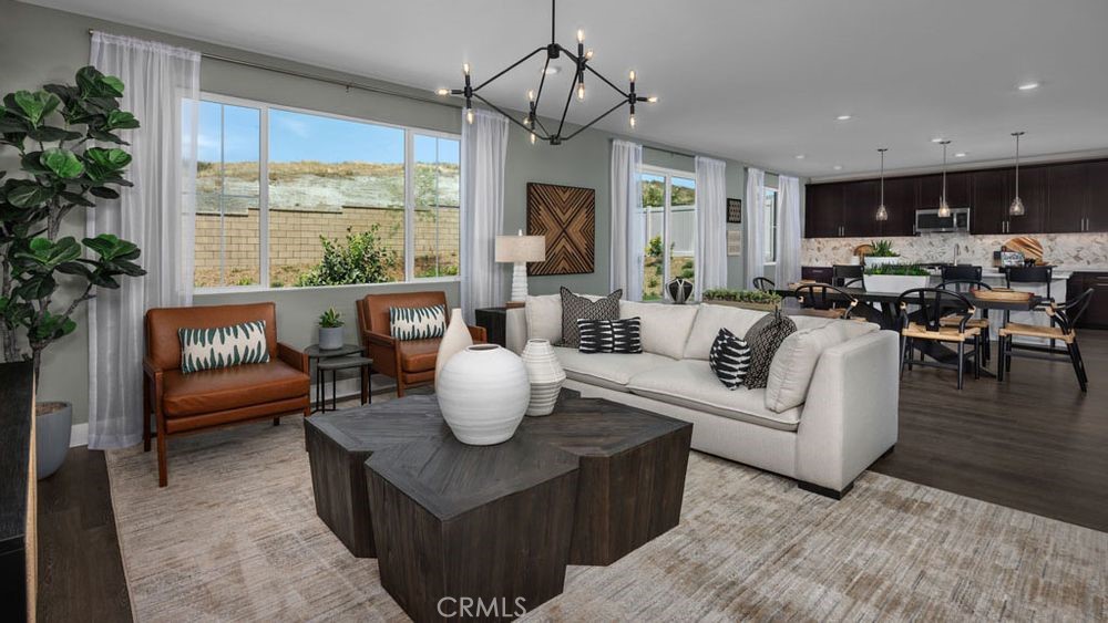 9565 Glenmore Frst Drive Riverside, CA 92508 - Photo 15 of 16 a living room with furniture a window and a chandelier