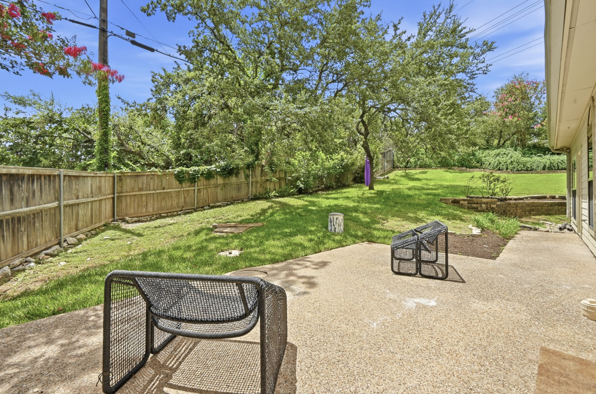 1107 Bowie Road Austin, TX 78733 - Photo 34 of 40 A spacious yard with mature trees and a fenced perimeter offers a private outdoor retreat.