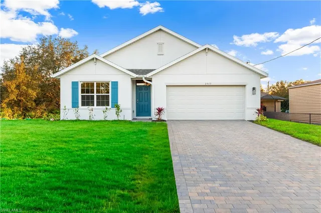 a front view of house with yard and green space