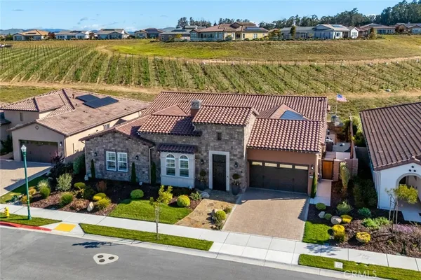 an aerial view of houses with outdoor space and swimming pool