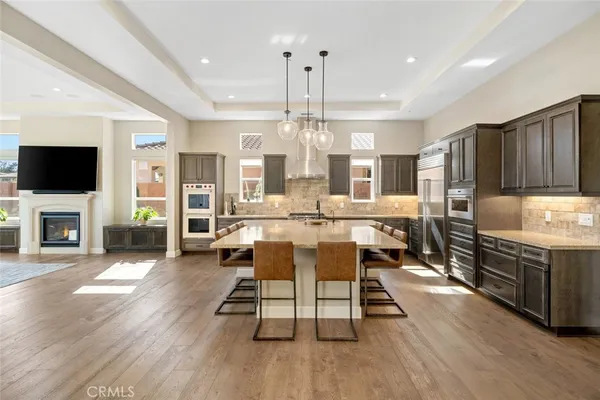 a large kitchen with cabinets table and chairs