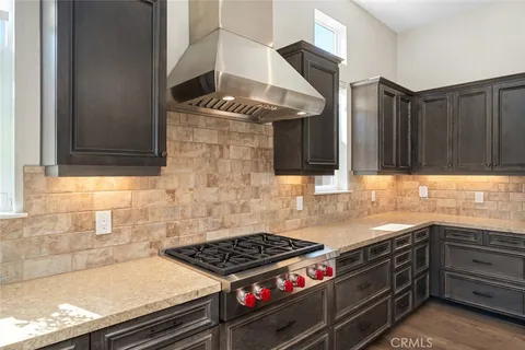 a kitchen with granite countertop a stove and a sink