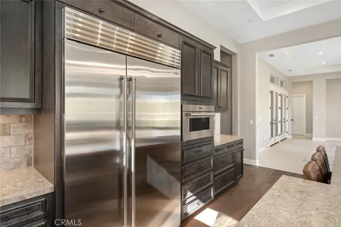 a kitchen with granite countertop stainless steel appliances and a refrigerator