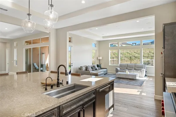 a kitchen with sink stove and living room