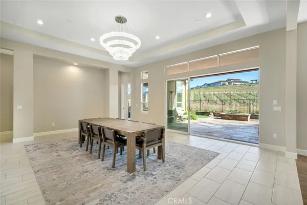a dining room with furniture and a large window