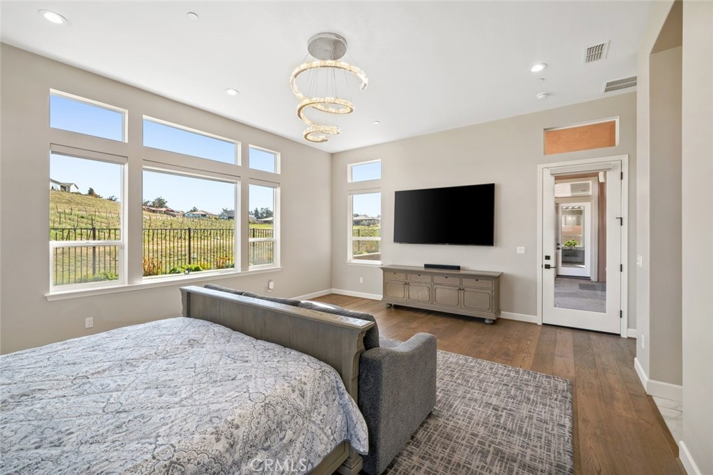 981 Trail View Place Nipomo, CA 93444 - Photo 27 of 56 a bedroom with a bed and a flat screen tv