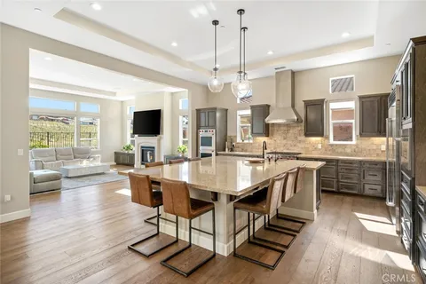 a large kitchen with kitchen island a large island in the center and stainless steel appliances
