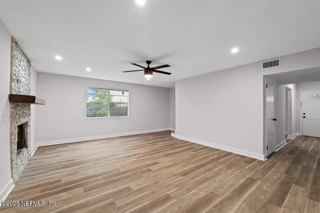 wooden floor in an empty room with a window