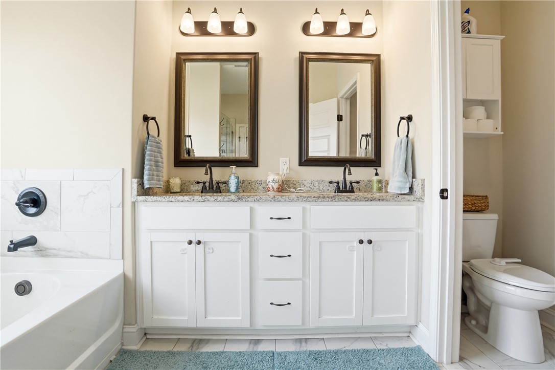 122 Allie Loop Brunswick, GA 31525 - Photo 18 of 31 Primary ensuite with double vanity and separate shower/soaking tub.