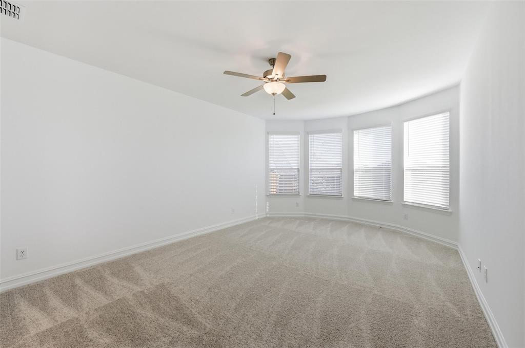 4365 Knight Street Midlothian, TX 76065 - Photo 11 of 33 an empty room with windows and fan