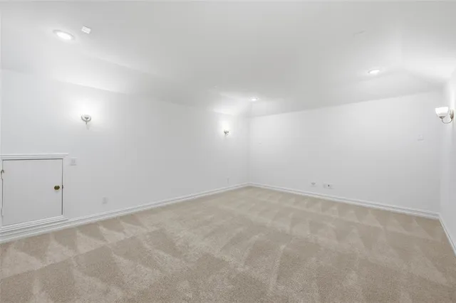 an empty room with white walls and tiles