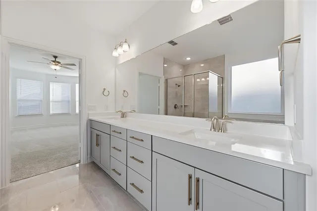 a bathroom with a double vanity sink and a mirror