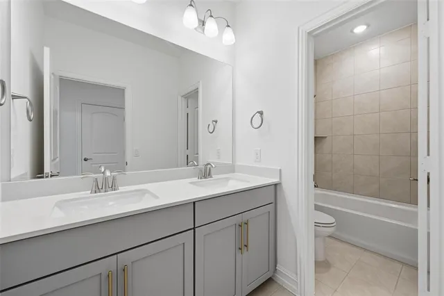 a bathroom with a sink double vanity granite tub and shower
