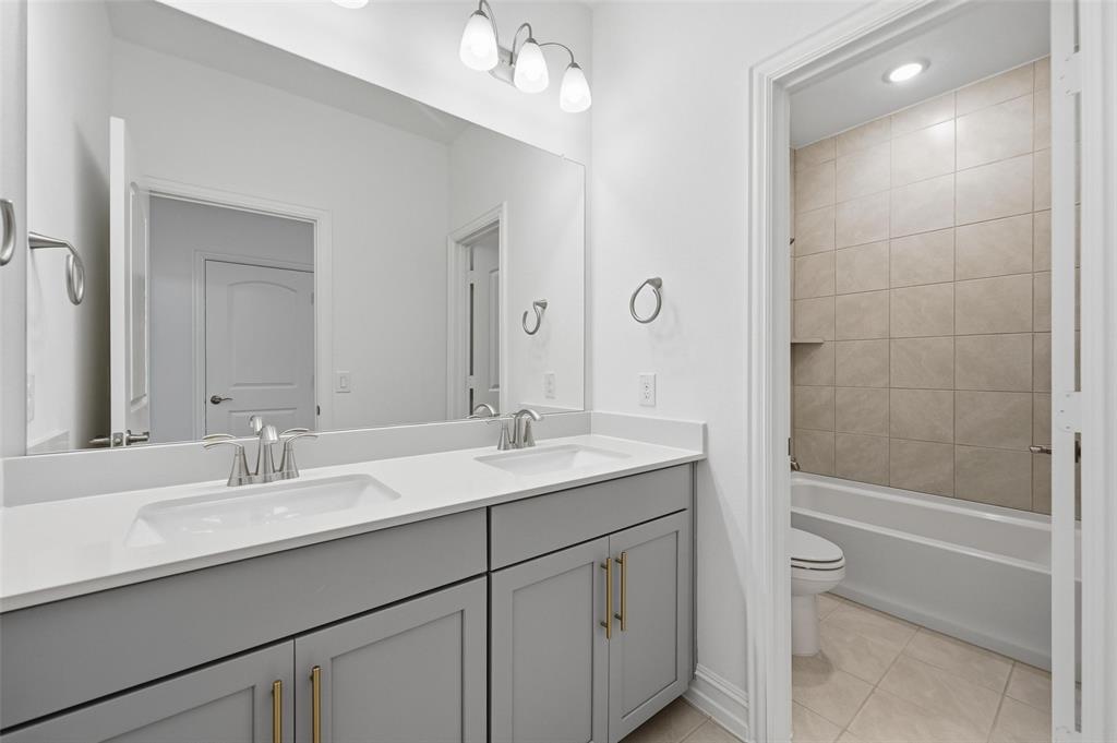 4365 Knight Street Midlothian, TX 76065 - Photo 20 of 33 a bathroom with a sink double vanity granite tub and shower