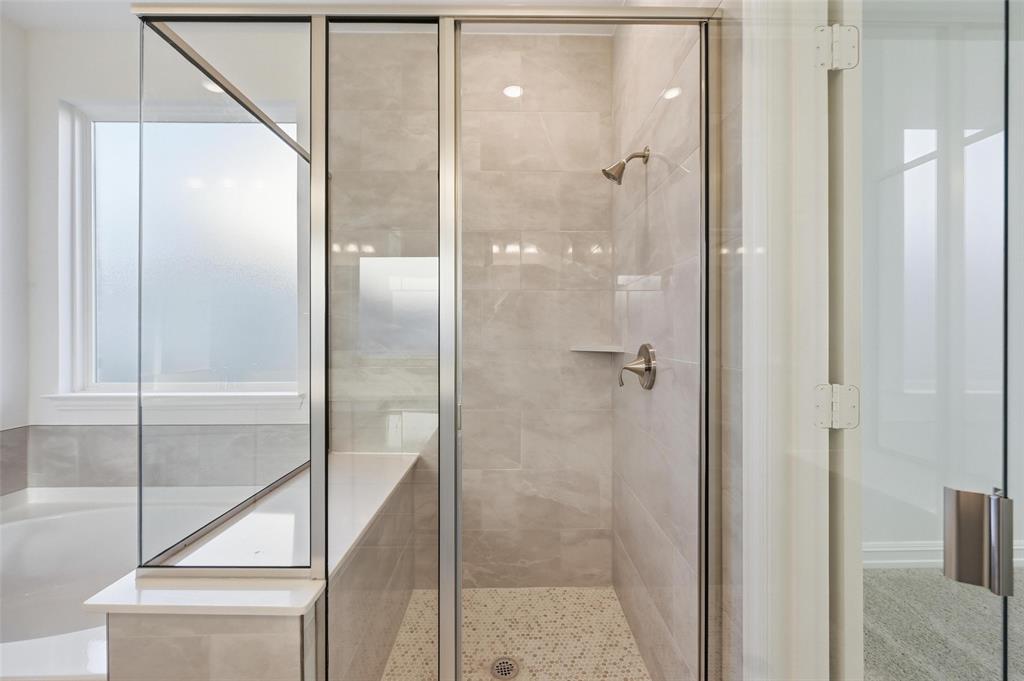4365 Knight Street Midlothian, TX 76065 - Photo 23 of 33 a bathroom with a glass shower door